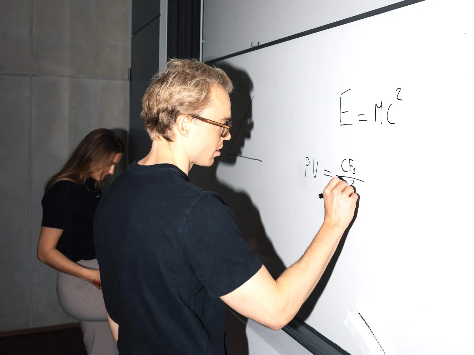 Kim teaching university students at a whiteboard